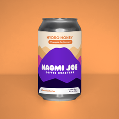 Hydro Honey Paradise Series coffee can on a tangerine background