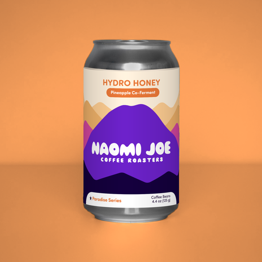 Hydro Honey Paradise Series coffee can on a tangerine background
